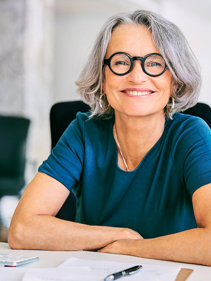 Elderly business lady smiling at the camera