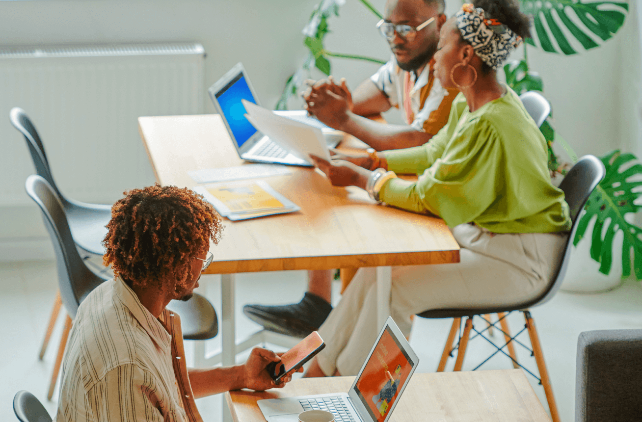 People at desks on devices working